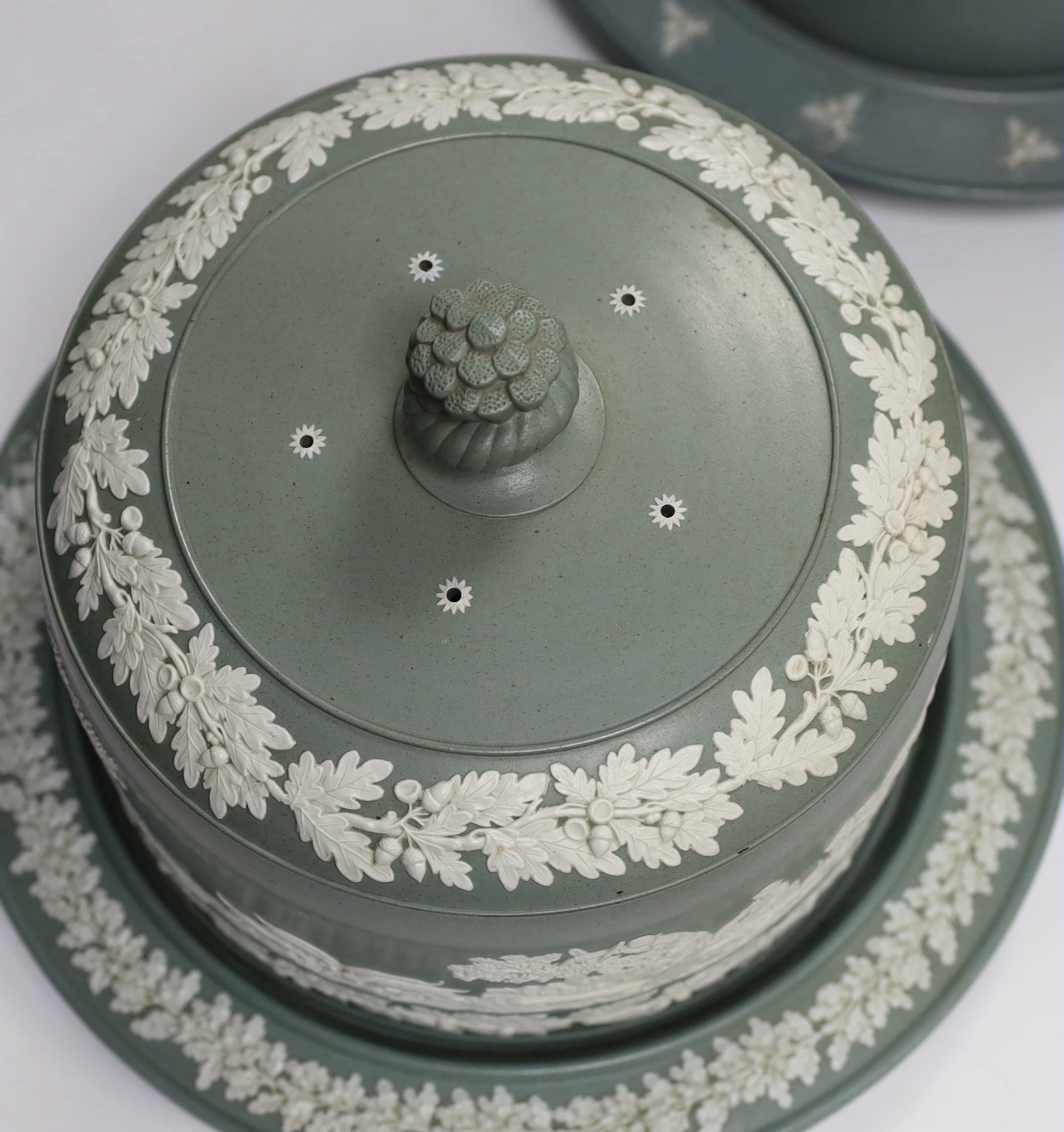 Two Victorian Dudson green glazed and white sprigged cheese dishes and covers, tallest 29cm